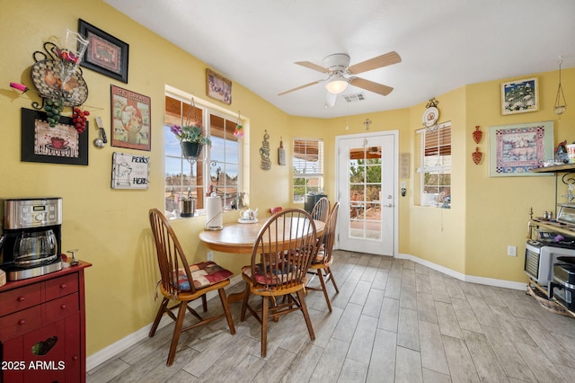 dining room featuring visible vents, plenty of natural light, light wood-style flooring, and baseboards