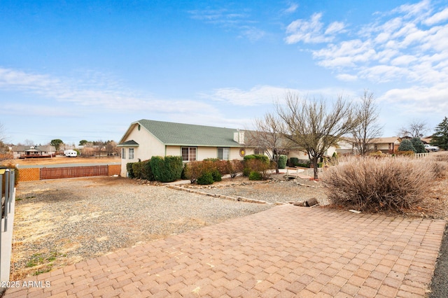 single story home featuring fence