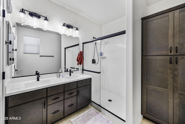 full bathroom with double vanity, a stall shower, and a sink