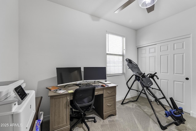 office area with ceiling fan, baseboards, and light colored carpet