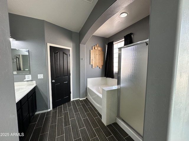 bathroom with vanity and independent shower and bath