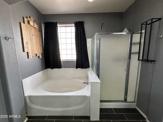 bathroom featuring shower with separate bathtub