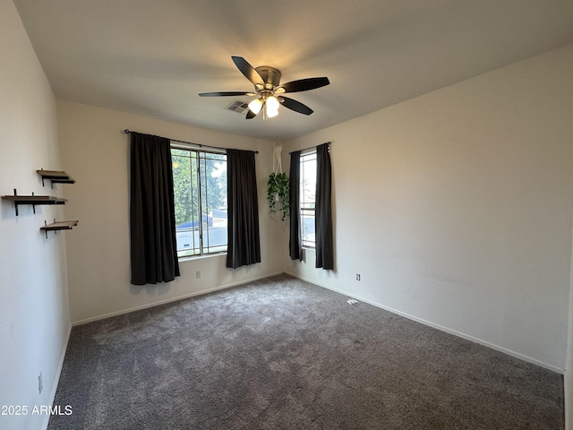 carpeted spare room with ceiling fan