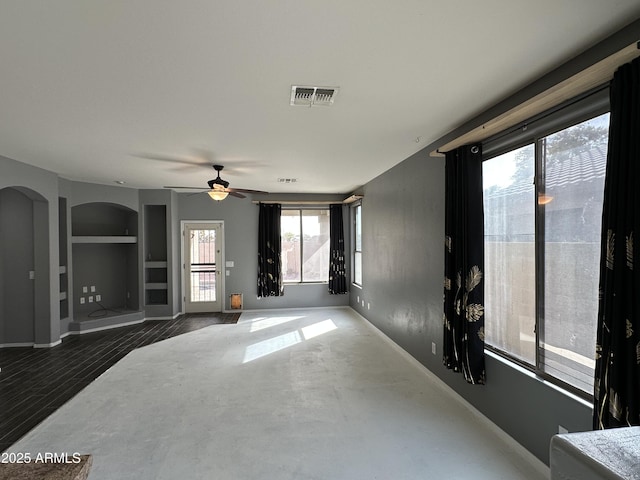 unfurnished living room featuring hardwood / wood-style floors, built in features, and ceiling fan