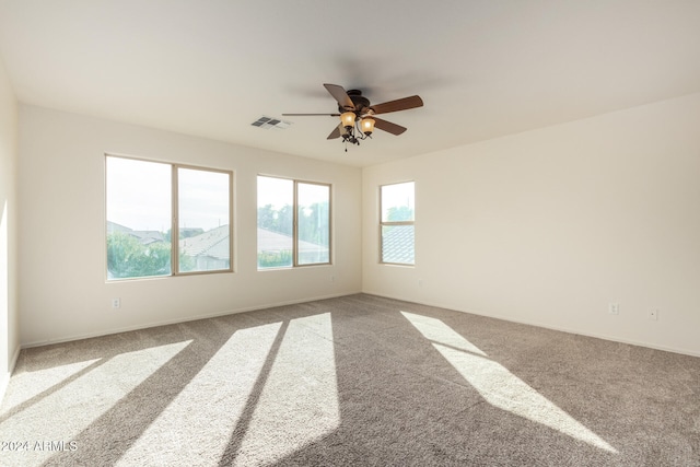 spare room featuring ceiling fan and carpet floors