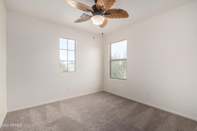 spare room featuring carpet and ceiling fan