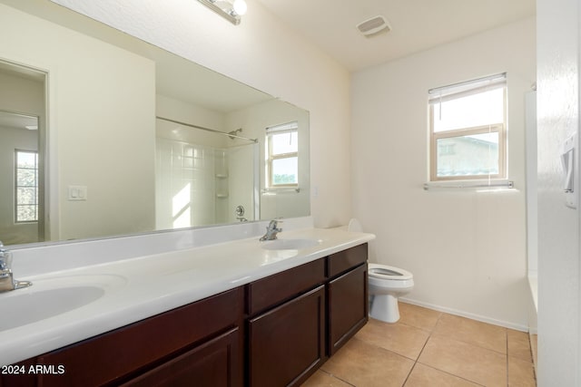 bathroom with plenty of natural light, vanity, and tile patterned flooring