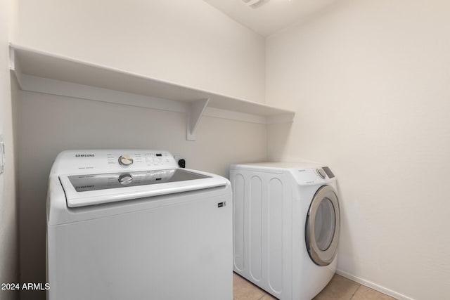 laundry room with light tile patterned flooring and separate washer and dryer