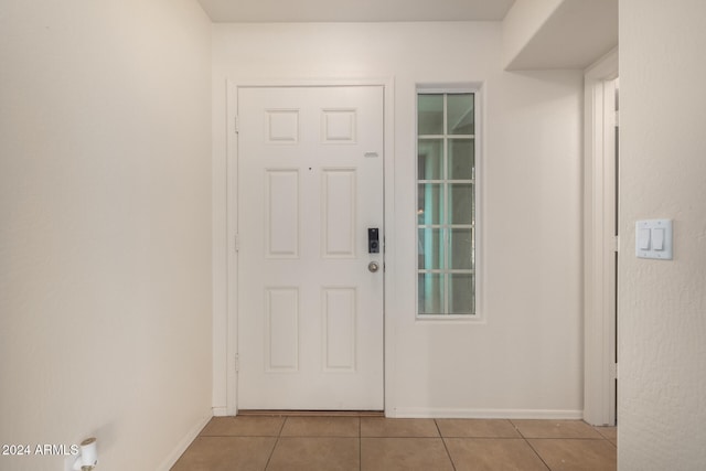 doorway with light tile patterned flooring