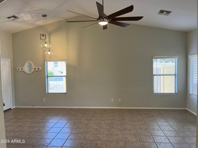 empty room featuring high vaulted ceiling, visible vents, baseboards, and a ceiling fan