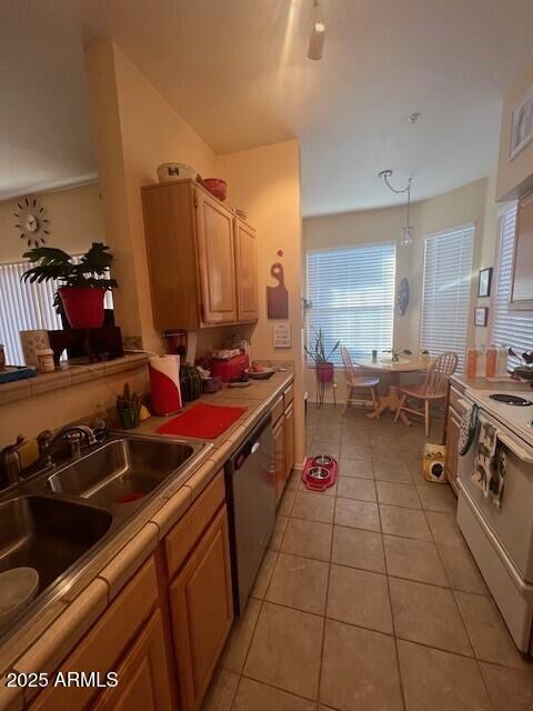 14950 W Mountain View Blvd Unit 5303, Surprise, AZ 85374 - kitchen with dishwasher, white electric range oven, light tile patterned floors, light countertops, and a sink