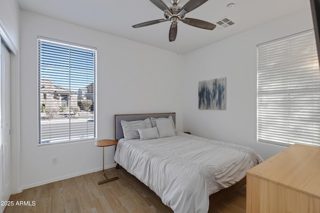 bedroom featuring hardwood / wood-style flooring, ceiling fan, and a closet