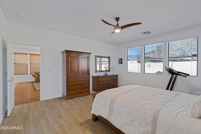 bedroom with ceiling fan, light hardwood / wood-style floors, and multiple windows