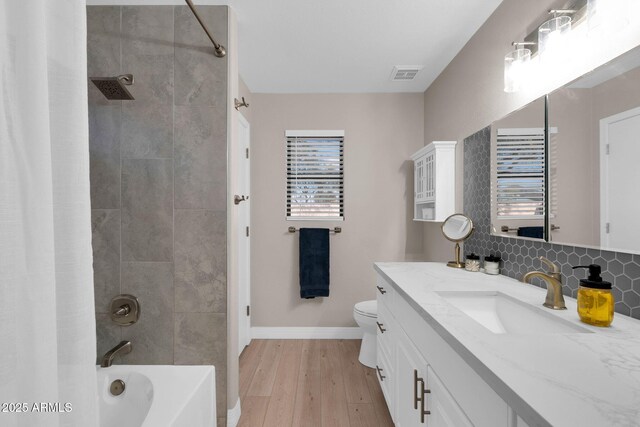 21640 N 48th St, Phoenix, AZ 85054 - full bath with tasteful backsplash, visible vents, toilet, wood finished floors, and shower / tub combo with curtain