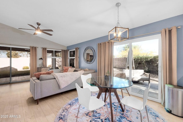21640 N 48th St, Phoenix, AZ 85054 - dining space featuring light wood-type flooring, vaulted ceiling, and ceiling fan with notable chandelier