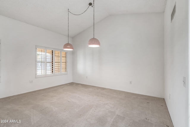 unfurnished room with carpet floors, a textured ceiling, and vaulted ceiling