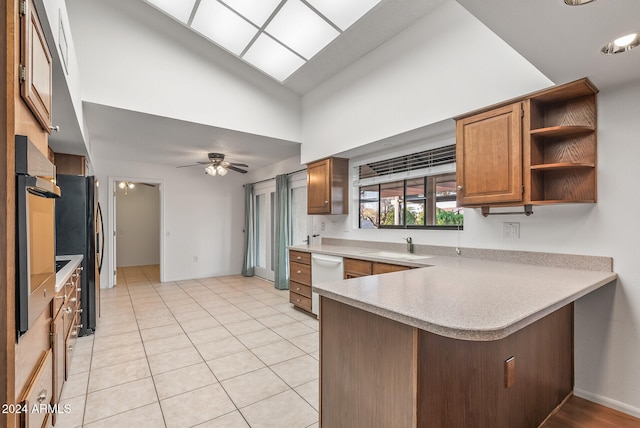 kitchen featuring high vaulted ceiling, ceiling fan, kitchen peninsula, white dishwasher, and light tile patterned floors