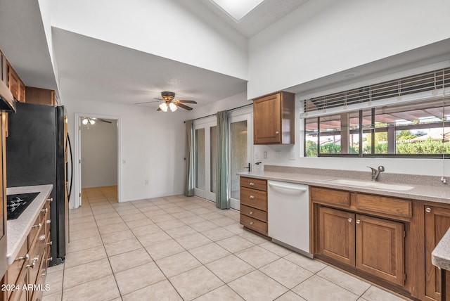 kitchen featuring white dishwasher, ceiling fan, sink, and light tile patterned floors