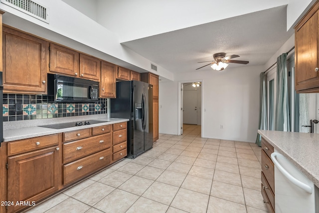 kitchen featuring decorative backsplash, black appliances, light tile patterned floors, and ceiling fan