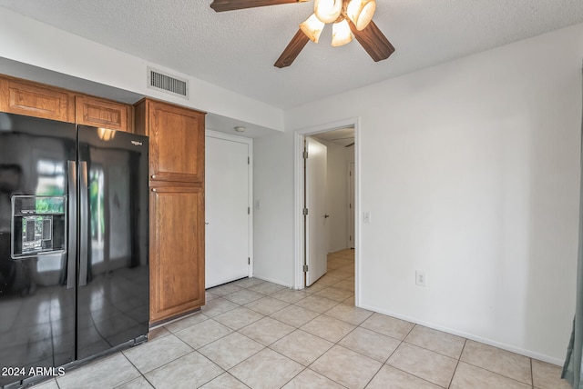 kitchen featuring light tile patterned flooring, ceiling fan, black fridge with ice dispenser, and a textured ceiling