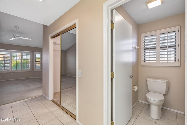 bathroom with tile patterned floors, ceiling fan, and toilet