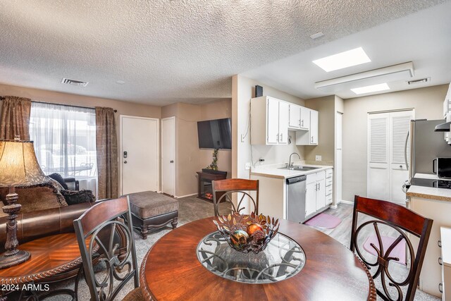 dining area with a textured ceiling and sink