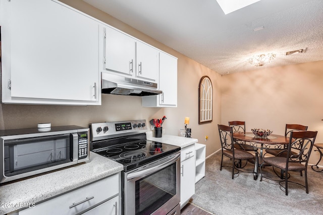 kitchen with white cabinetry, a textured ceiling, and appliances with stainless steel finishes