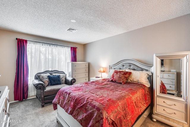 bedroom featuring carpet floors and a textured ceiling