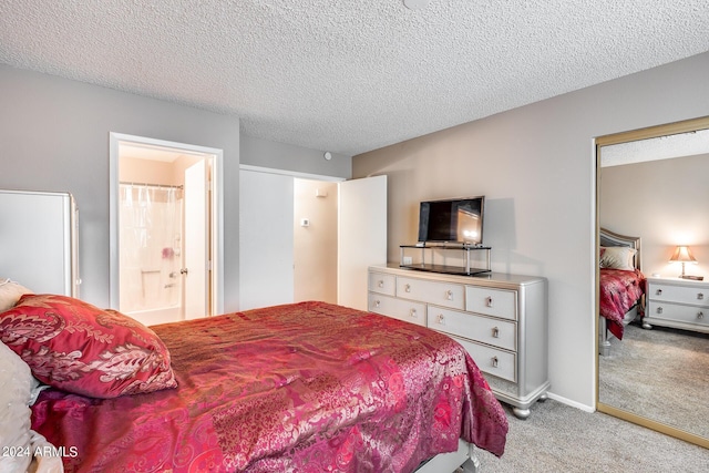 carpeted bedroom with a textured ceiling and connected bathroom