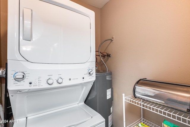 washroom with stacked washer and dryer and water heater