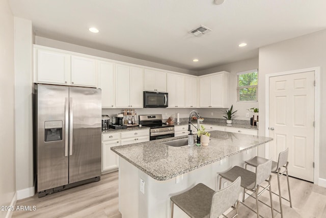 263 N Wilson Dr, Chandler, AZ 85225 - kitchen featuring stainless steel appliances, light wood-type flooring, light stone counters, white cabinets, and recessed lighting