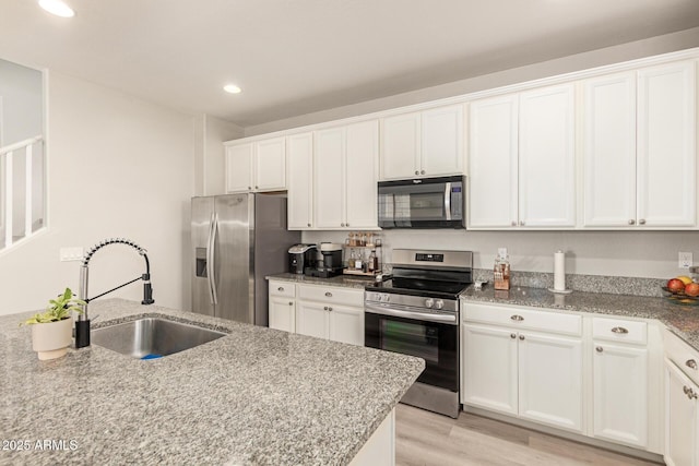 263 N Wilson Dr, Chandler, AZ 85225 - kitchen featuring stainless steel appliances, recessed lighting, white cabinets, light stone countertops, and light wood-type flooring