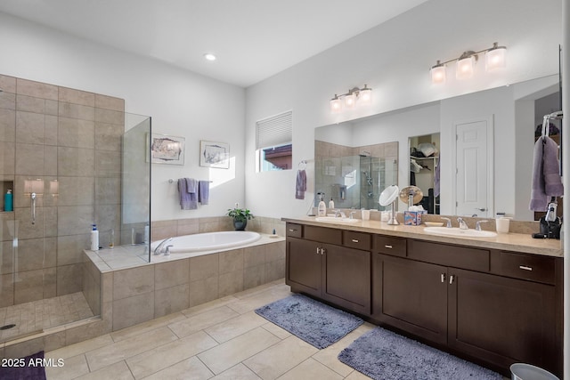 bathroom with independent shower and bath, tile patterned floors, and vanity