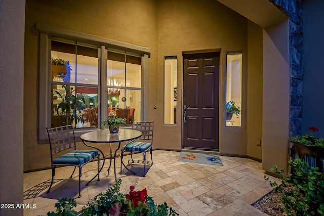 property entrance featuring a patio area