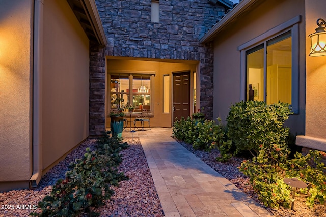 view of exterior entry featuring a patio