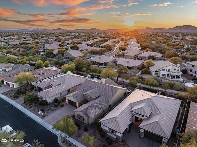 aerial view at dusk featuring a mountain view