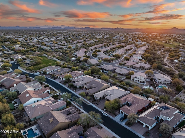 aerial view at dusk featuring a mountain view