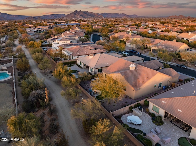 aerial view at dusk featuring a mountain view