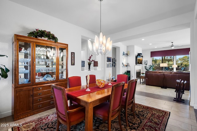 dining space featuring ceiling fan with notable chandelier