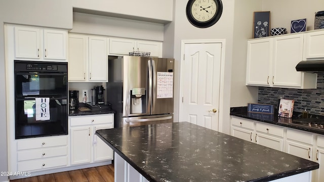 kitchen with dark wood-type flooring, white cabinets, black double oven, stainless steel fridge with ice dispenser, and extractor fan