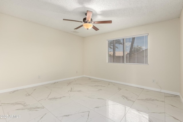 643 W Medina Ave, Mesa, AZ 85210 - unfurnished room with ceiling fan, baseboards, marble look tile flooring, and a textured ceiling