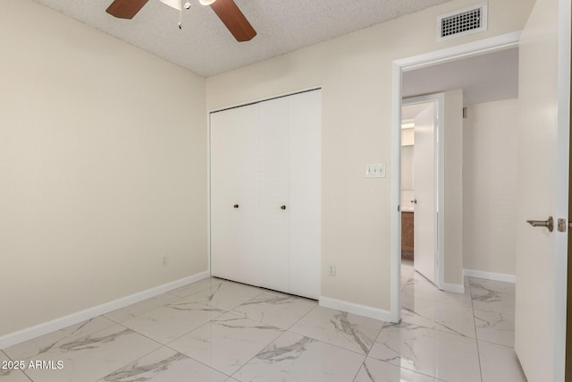 643 W Medina Ave, Mesa, AZ 85210 - unfurnished bedroom featuring light marble finish flooring, baseboards, a closet, and ceiling fan