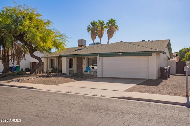 643 W Medina Ave, Mesa, AZ 85210 - ranch-style home featuring a garage, driveway, stucco siding, and a gate