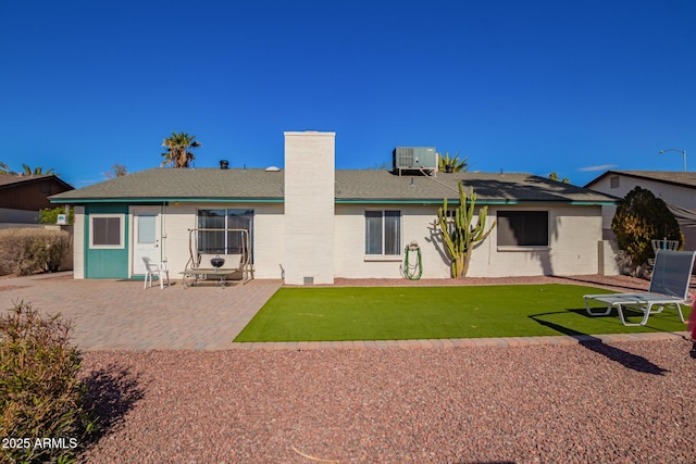 643 W Medina Ave, Mesa, AZ 85210 - back of property with a chimney, a patio area, a yard, and central air condition unit