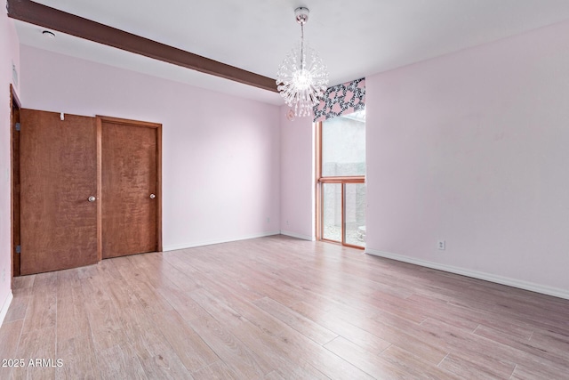 17346 E Oro Grande Dr, Fountain Hills, AZ 85268 - empty room with an inviting chandelier, light wood-style flooring, baseboards, and beamed ceiling