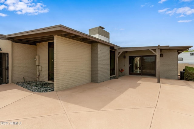 17346 E Oro Grande Dr, Fountain Hills, AZ 85268 - view of front of house featuring brick siding, a chimney, and a patio area