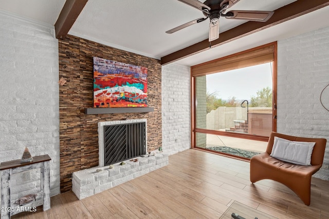 17346 E Oro Grande Dr, Fountain Hills, AZ 85268 - living room with beamed ceiling, a brick fireplace, ceiling fan, wood finished floors, and brick wall
