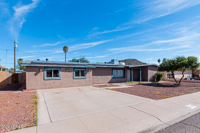 ranch-style home with solar panels