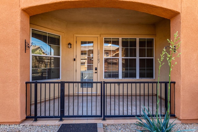 14575 W Mountain View Blvd Unit 12107, Surprise, AZ 85374 - doorway to property featuring covered porch and stucco siding