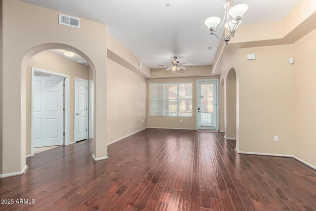 14575 W Mountain View Blvd Unit 12107, Surprise, AZ 85374 - unfurnished living room featuring visible vents, arched walkways, dark wood-style flooring, and ceiling fan with notable chandelier
